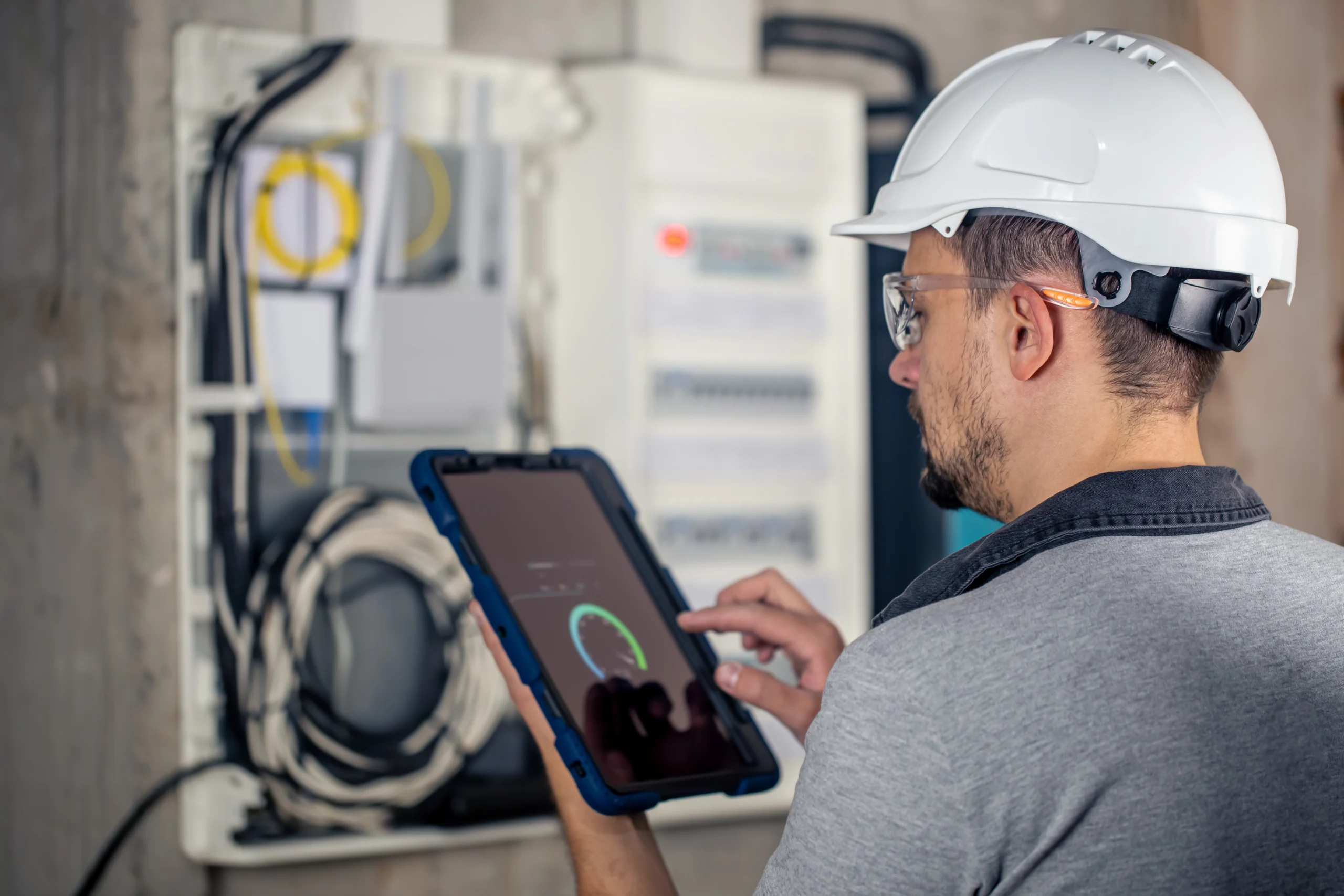 EPC Certs assessor recording heating system details on a tablet during an energy assessment